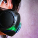 An image of someone wearing Razer's Zephyr mask, which is partially lit up to show some blues, greens, and purples.